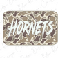 A camouflage-patterned rectangular object with the word "Horns" written in a bold, stylized font.