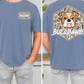 a man wearing a blue t-shirt with a graphic of a bulldog and the text "Bulldogs" printed on the back.
