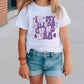 a little girl wearing a white shirt and blue shorts