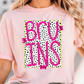 A woman wearing a pink t-shirt with the word "BRUINS" printed on it in pink and black polka dot letters.