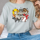 a woman sitting on top of a bed wearing a t - shirt