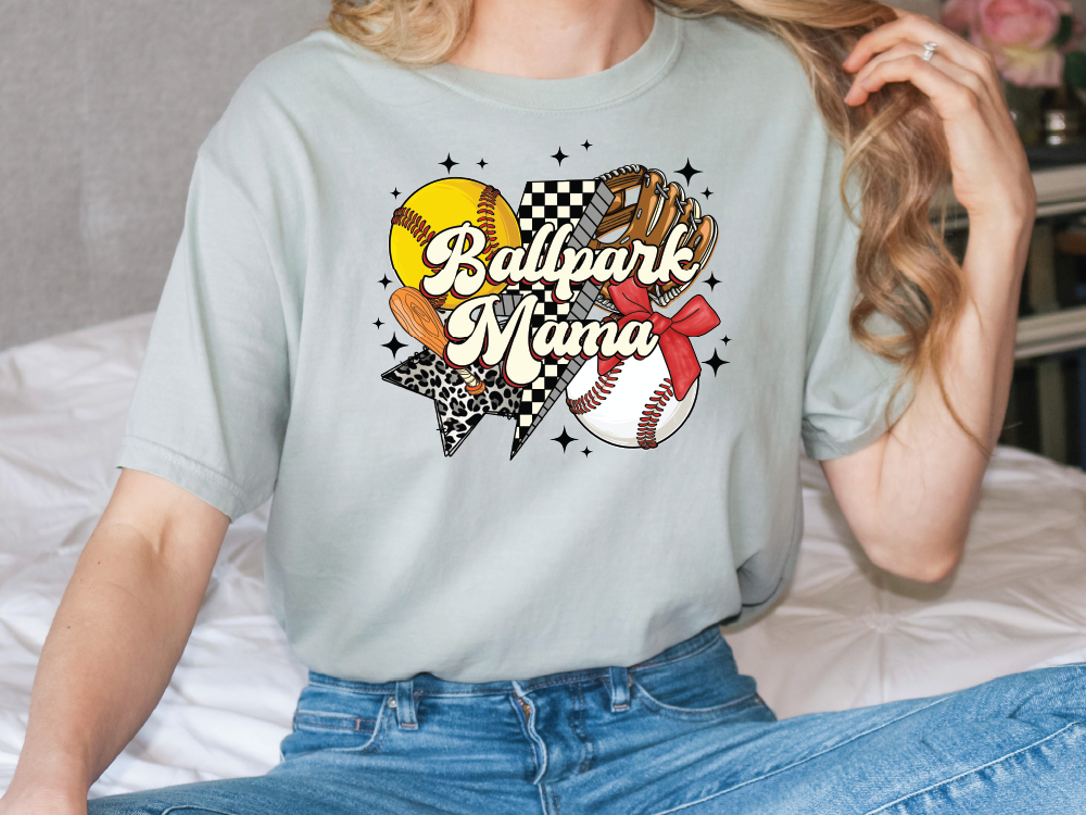 a woman sitting on top of a bed wearing a t - shirt