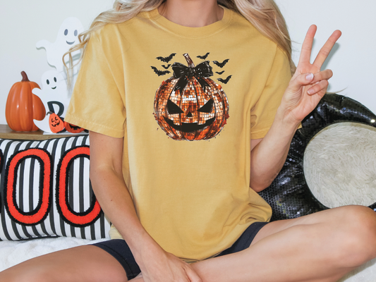 a woman sitting on a bed holding a peace sign