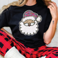 a woman sitting on a couch wearing a santa clause t - shirt