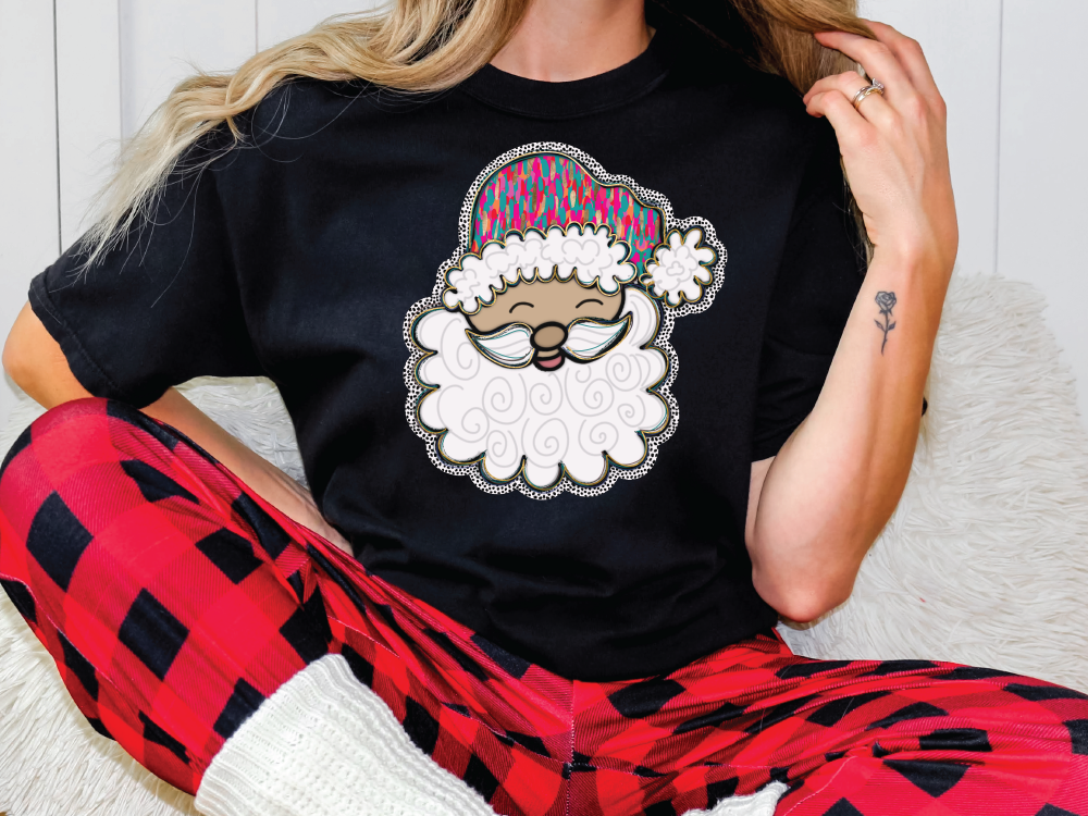 a woman sitting on a couch wearing a santa clause t - shirt