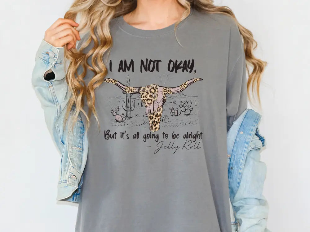 a woman wearing a gray shirt with a cow on it