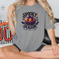 a woman sitting on a bed wearing a halloween t - shirt