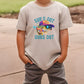 a young boy wearing a t - shirt that says surf's out guns out