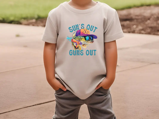 a young boy wearing a t - shirt that says surf's out guns out