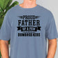 a man wearing a blue t - shirt that says proud father of a few dumb