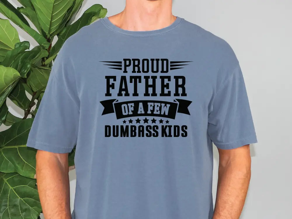 a man wearing a blue t - shirt that says proud father of a few dumb