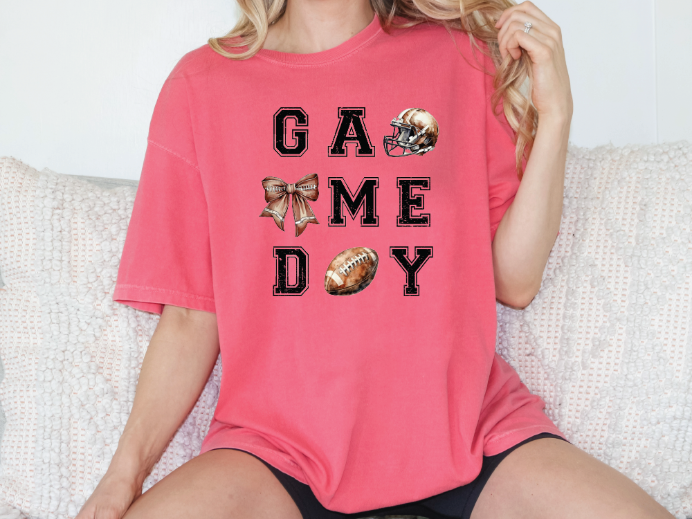 a woman sitting on a couch wearing a game day shirt