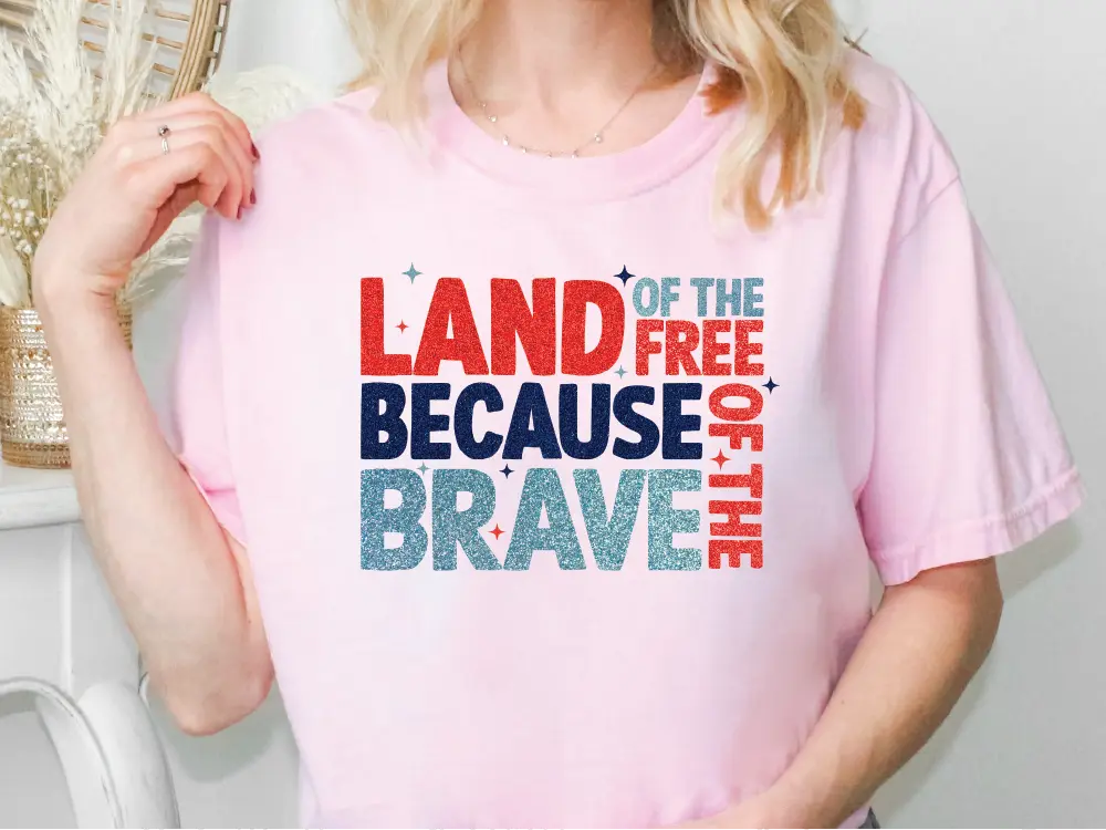 a blonde woman wearing a pink land of the free because of the brave t -