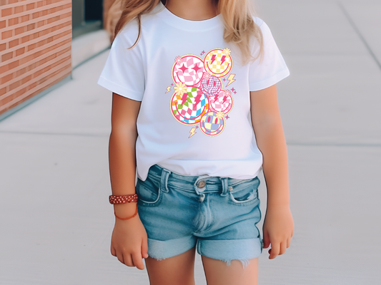 a little girl wearing a white shirt and shorts