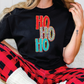 a woman sitting on a couch wearing a t - shirt with the word ho ho