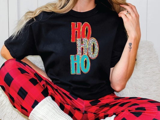 a woman sitting on a couch wearing a t - shirt with the word ho ho