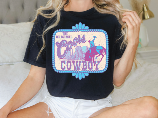 a woman sitting on a bed wearing a cowgirl shirt