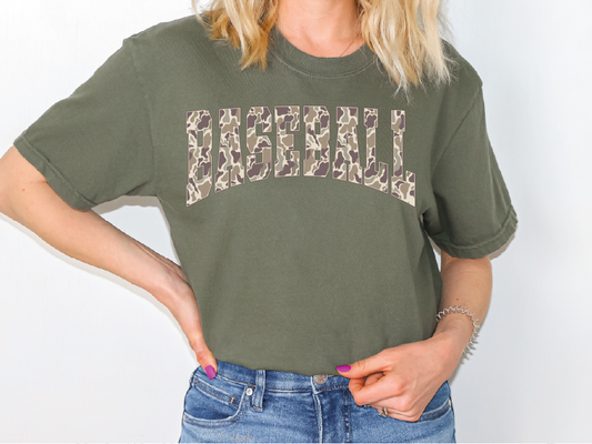 A woman wearing a green t-shirt with the word "BASEBALL" printed on it.