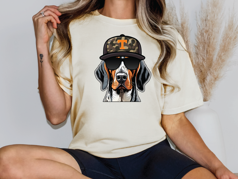 a woman wearing a t - shirt with a dog wearing a hat