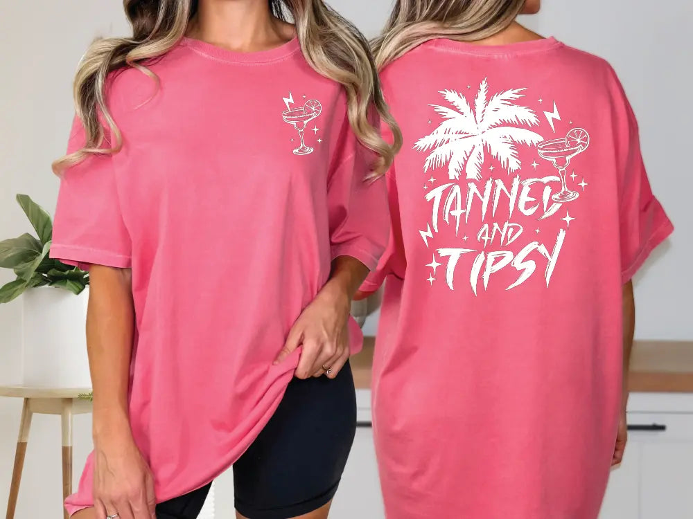 two women wearing pink shirts with palm trees on them