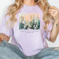 a woman wearing a t - shirt with flowers on it