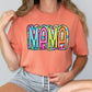 a woman wearing a pink shirt with the word mama printed on it