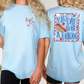 a woman wearing a blue shirt with a hot dog on it