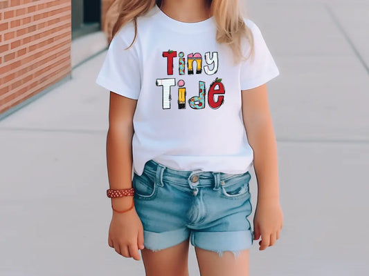 a little girl wearing a tiny time t - shirt