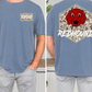 a man wearing a blue t-shirt with a graphic of a red dog's face and the text "REDHOUNDS" printed on the back.