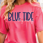 A woman wearing a pink t-shirt with the text "BLUE TIDE long county" printed on it.