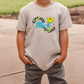 a young boy wearing a t - shirt with a smiley face on it