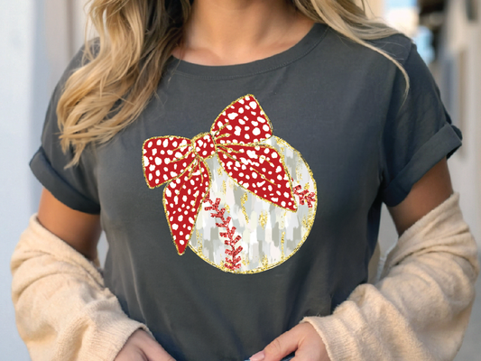 a woman wearing a black shirt with a red bow on it