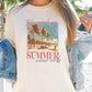 a woman wearing a t - shirt with a picture of a beach and palm trees