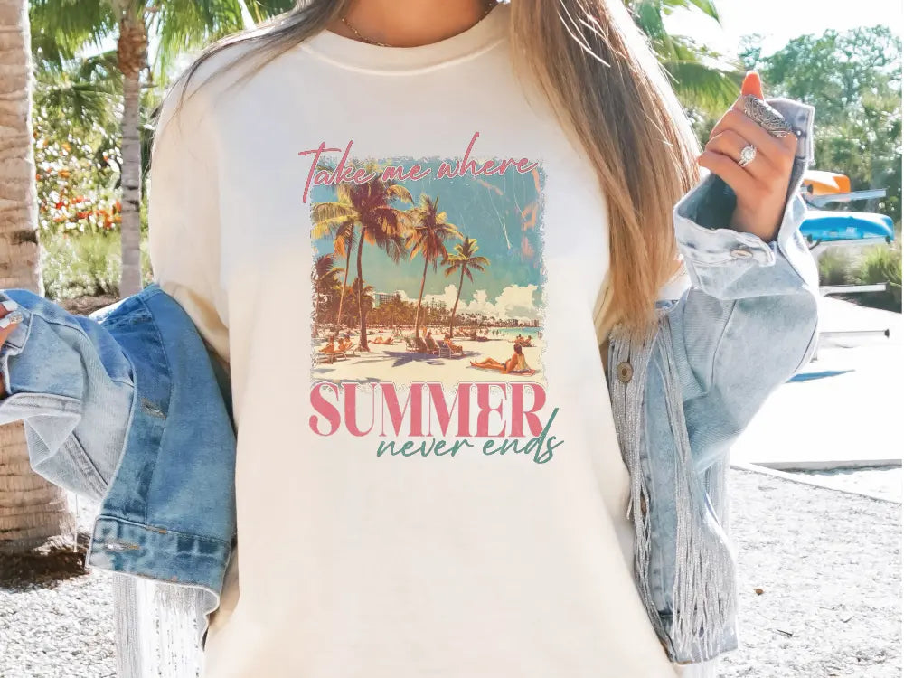 a woman wearing a t - shirt with a picture of a beach and palm trees