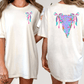 two women wearing white t-shirts with colorful, abstract designs on the back.