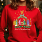 A red sweater with a Christmas nativity scene design on it.