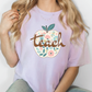 a woman wearing a t - shirt with a flowered apple on it