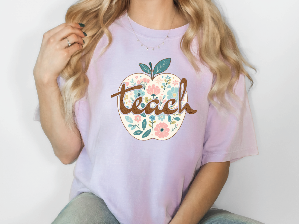 a woman wearing a t - shirt with a flowered apple on it