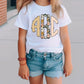 a little girl wearing a white shirt and denim shorts