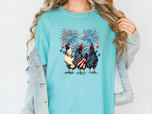 a woman wearing a t - shirt with two chickens on it