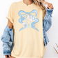 A woman wearing a yellow t-shirt with a blue bow and the text "Blue Tide" printed on it, along with a denim jacket.