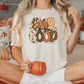 a woman sitting on a bed holding a pumpkin