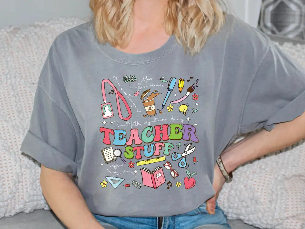 a woman sitting on a couch wearing a teacher stuff shirt