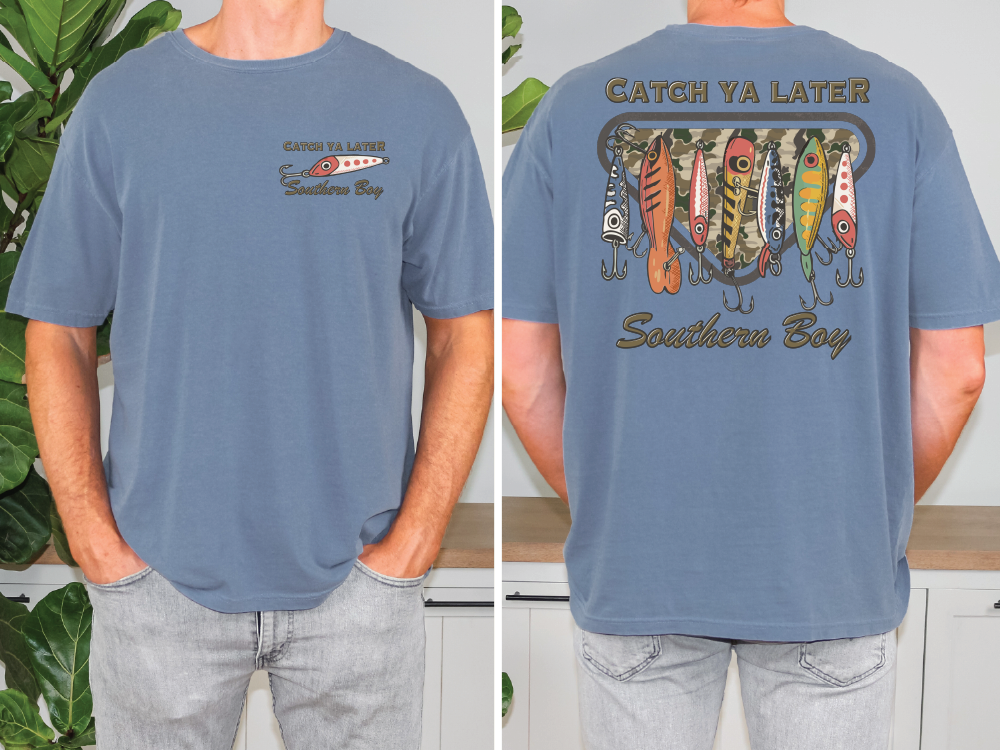 a man wearing a blue t-shirt with a graphic design featuring fishing lures and the text "Catch Ya Later Southern Boy".