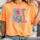 a woman sitting on a railing wearing an orange tshirt