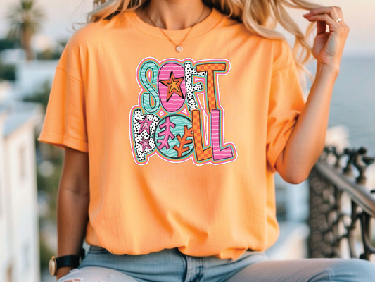 a woman sitting on a railing wearing an orange tshirt