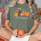 a woman sitting on a bed holding a pumpkin