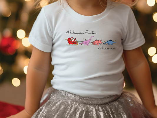 a little girl wearing a white shirt and silver skirt