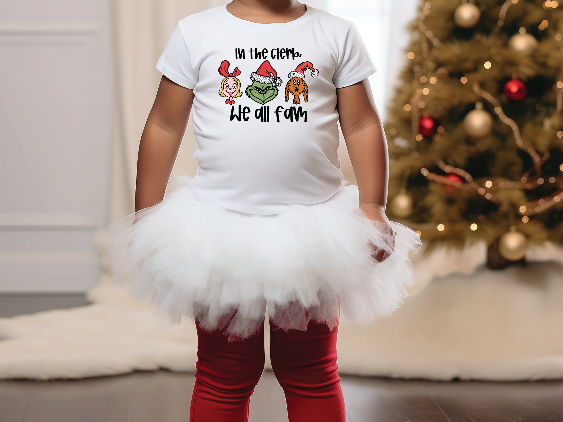 a little girl standing in front of a christmas tree