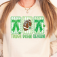 A woman wearing a white sweatshirt with a graphic design featuring a football, green bows, and the text "TOUCH DOWN SEASON".